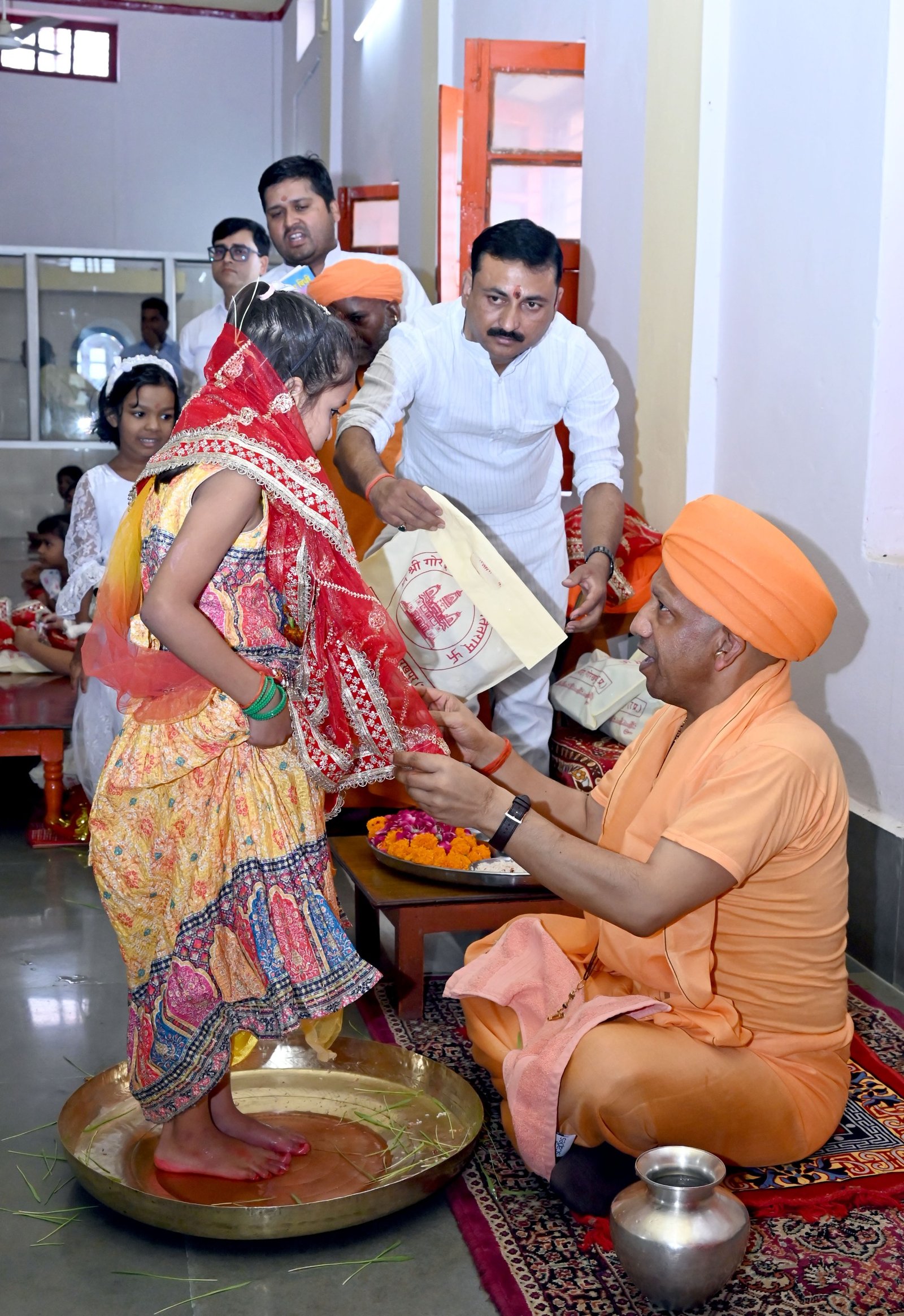 Yogi Adityanath worships the divine feminine by washing the feet of young girls